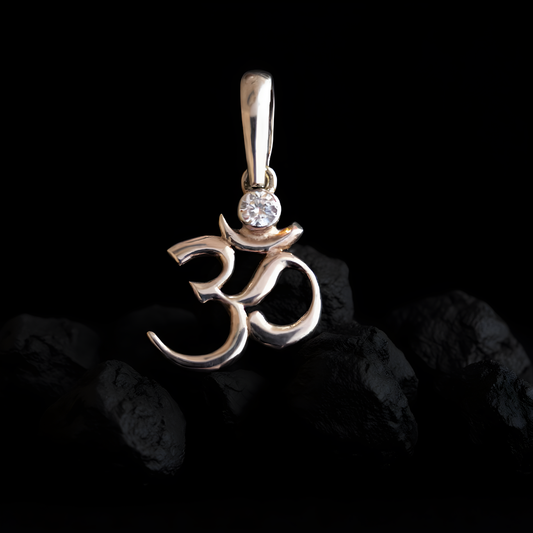 Sterling silver Om symbol pendant with white cubic zirconia, inspired by Hindu and Buddhist spirituality, minimalist design by Indigo Jewelry.