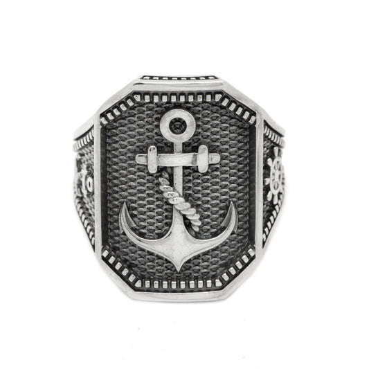Sterling silver anchor ring for men with blackened texture and nautical design. Statement ring featuring raised anchor and helm engraving. Bold sea anchor signet ring, perfect ocean-inspired gift for sailors, navy fans, or pirate jewelry collectors. Rugged men's silver ring with maritime symbolism.