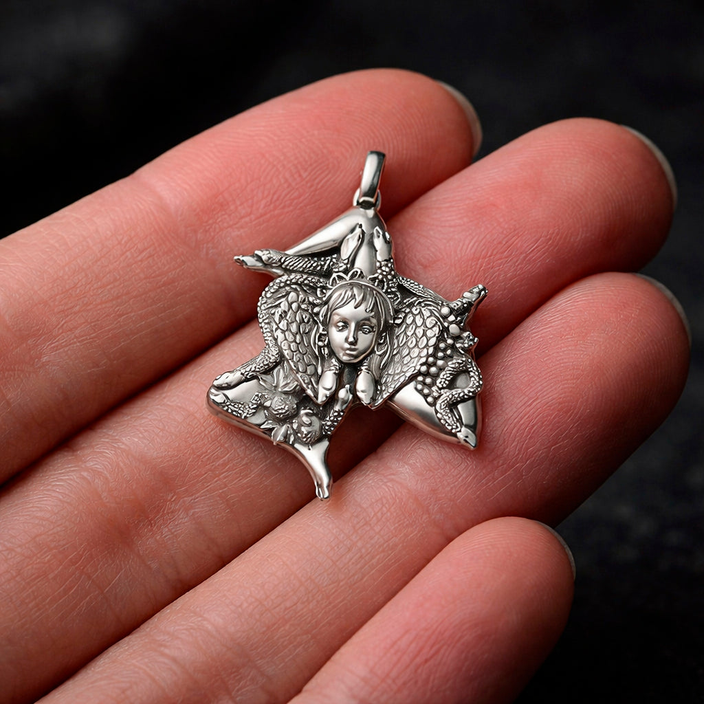 Detailed view of a handcrafted sterling silver Trinacria pendant by Indigo Jewelry. The design features a central Medusa Gorgon head with expressive facial features, surrounded by three bent running legs and interwoven stalks of wheat, symbolizing Sicilian heritage and fertility. The oxidized silver finish highlights the intricate mythological textures. This authentic Mediterranean protection amulet is shown as a high-quality statement piece for women's jewelry collections.