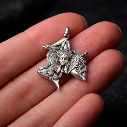 Detailed view of a handcrafted sterling silver Trinacria pendant by Indigo Jewelry. The design features a central Medusa Gorgon head with expressive facial features, surrounded by three bent running legs and interwoven stalks of wheat, symbolizing Sicilian heritage and fertility. The oxidized silver finish highlights the intricate mythological textures. This authentic Mediterranean protection amulet is shown as a high-quality statement piece for women's jewelry collections.