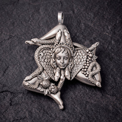 Detailed view of a handcrafted sterling silver Trinacria pendant by Indigo Jewelry. The design features a central Medusa Gorgon head with expressive facial features, surrounded by three bent running legs and interwoven stalks of wheat, symbolizing Sicilian heritage and fertility. The oxidized silver finish highlights the intricate mythological textures. This authentic Mediterranean protection amulet is shown as a high-quality statement piece for women's jewelry collections.