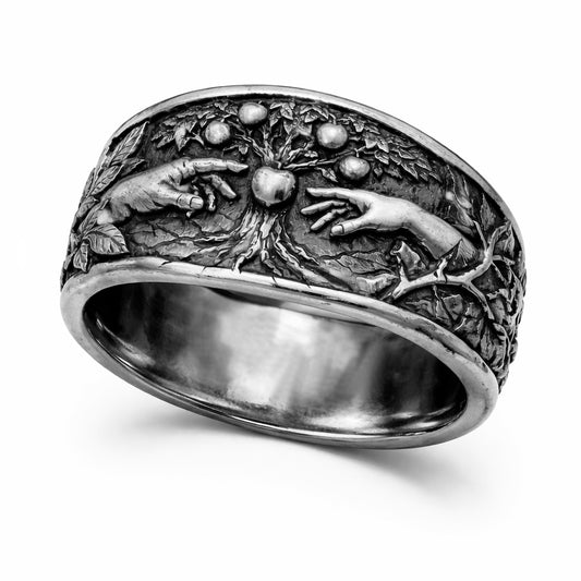 Oxidized sterling silver statement ring by Indigo Jewelry from the Human Paradox Collection. Artistic symbolic design featuring two hands reaching for the forbidden fruit, inspired by Lost Paradise and The Choice concept. Handcrafted silver ring with detailed relief, darkened blackened finish, conceptual jewelry, philosophical ring, art jewelry piece, unique designer silver ring, expressive narrative jewelry, bold textured band, meaningful wearable art.