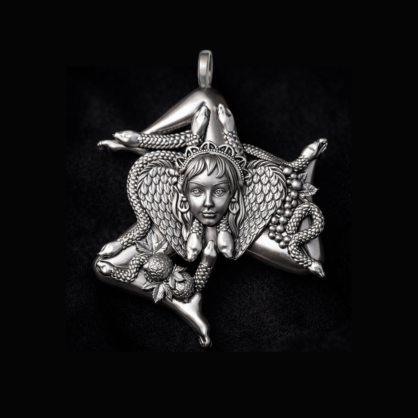 Detailed view of a handcrafted sterling silver Trinacria pendant by Indigo Jewelry. The design features a central Medusa Gorgon head with expressive facial features, surrounded by three bent running legs and interwoven stalks of wheat, symbolizing Sicilian heritage and fertility. The oxidized silver finish highlights the intricate mythological textures. This authentic Mediterranean protection amulet is shown as a high-quality statement piece for women's jewelry collections.