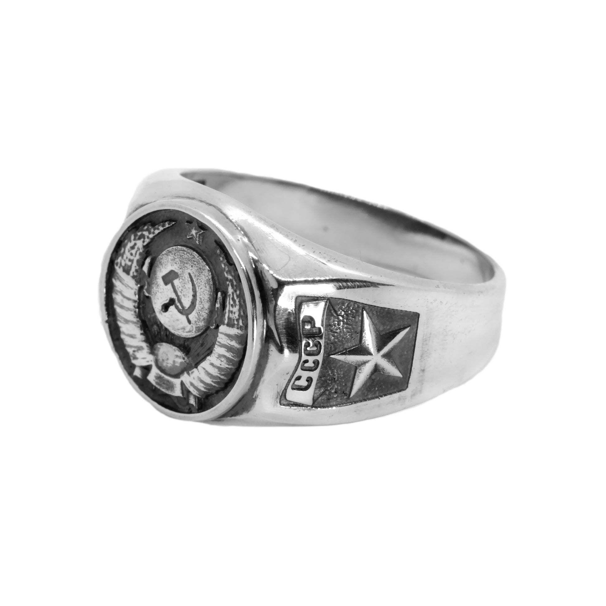 A silver ring with a Soviet emblem and a star on it.