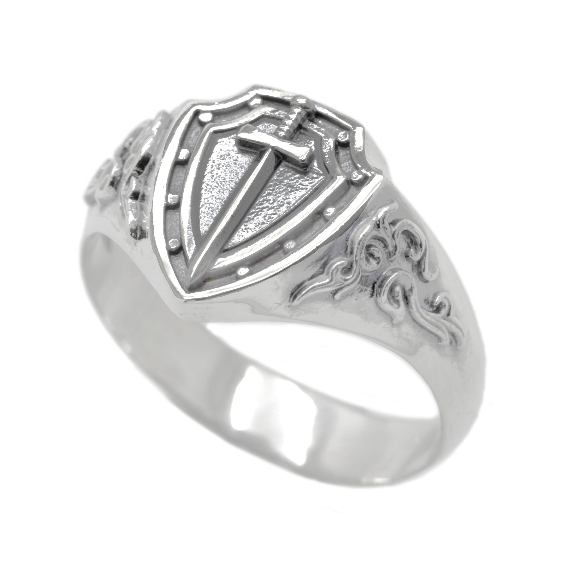 A silver ring with a shield-shaped design featuring a sword and intricate patterns.