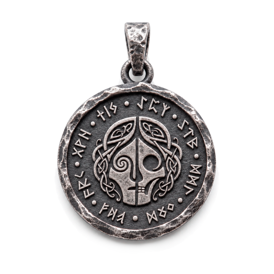 Hel pendant in 925 silver with a divided face, skull detail and runic border on white. INDIGO Jewelry.