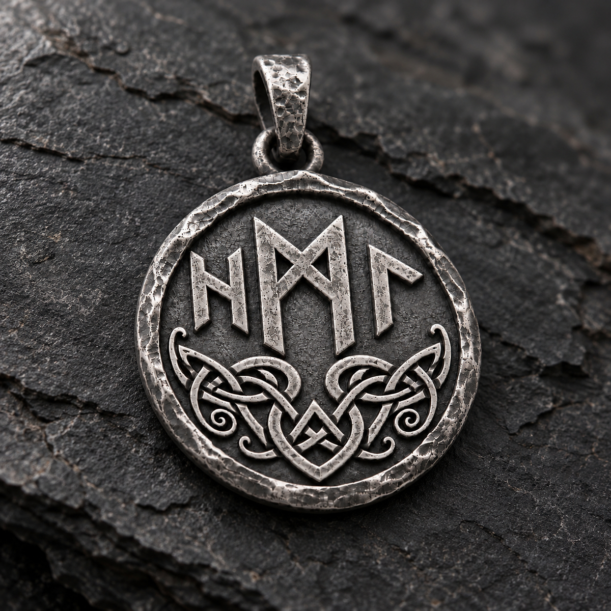 Angled reverse view of the silver Hel pendant with runes and knotwork on dark stone. INDIGO Jewelry.