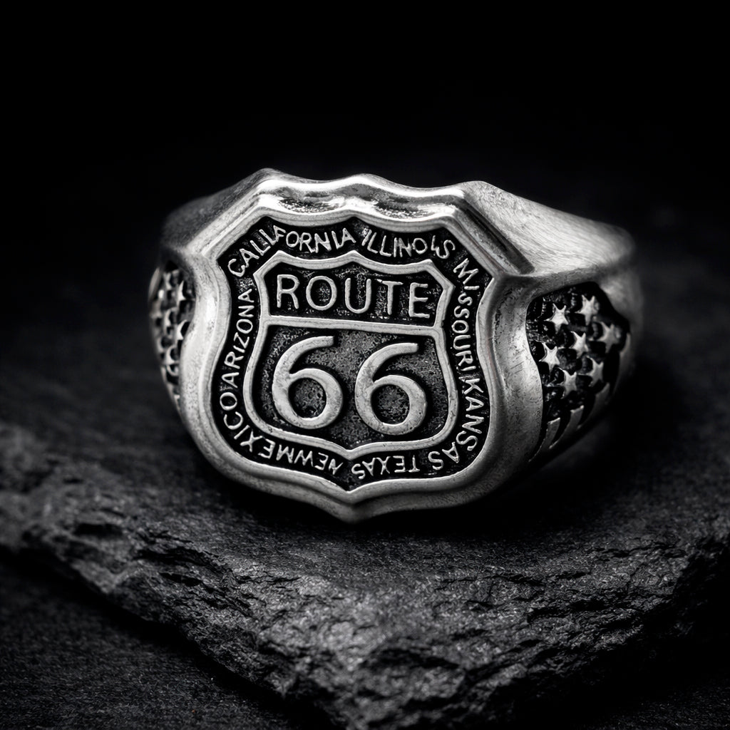 Route 66 sterling silver ring by Indigo Jewelry, men’s biker statement ring crafted from solid 925 silver with oxidized finish. Detailed Route 66 shield engraving with surrounding state names, bold vintage motorcycle jewelry design. Masculine rock style ring inspired by American highway culture, handcrafted silver band for riders, travelers, and lovers of road symbolism.