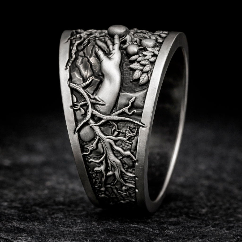 Oxidized sterling silver statement ring by Indigo Jewelry from the Human Paradox Collection. Artistic symbolic design featuring two hands reaching for the forbidden fruit, inspired by Lost Paradise and The Choice concept. Handcrafted silver ring with detailed relief, darkened blackened finish, conceptual jewelry, philosophical ring, art jewelry piece, unique designer silver ring, expressive narrative jewelry, bold textured band, meaningful wearable art.