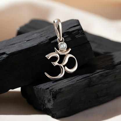 Sterling silver Om symbol pendant with white cubic zirconia, inspired by Hindu and Buddhist spirituality, minimalist design by Indigo Jewelry.