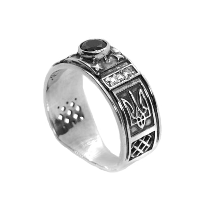 A silver ring with a central stone and intricate metalwork designs.