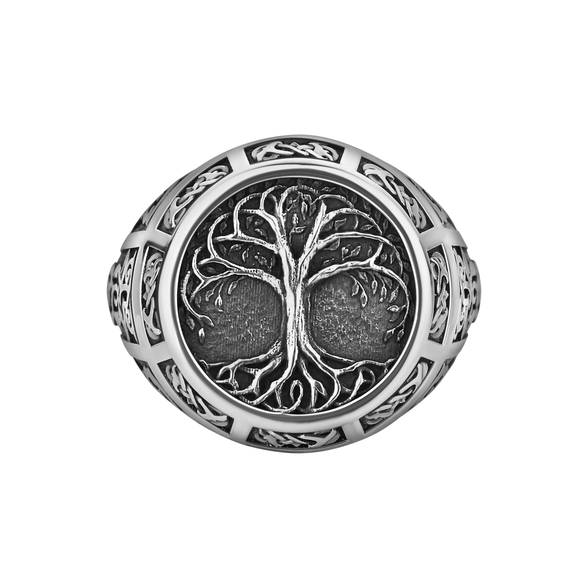 A silver ring with an intricate tree design on the center.