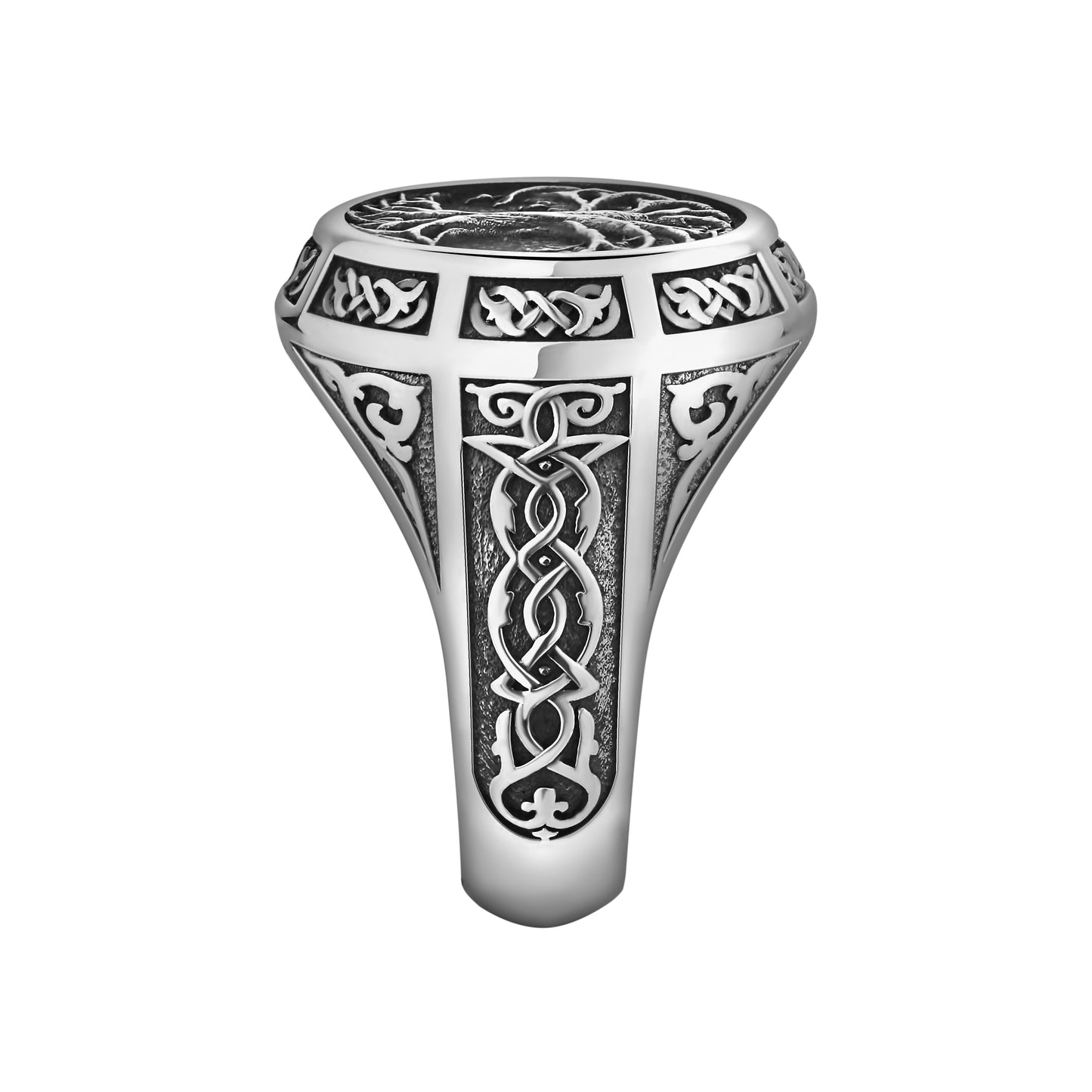 A silver ring with intricate, ornate designs and patterns, including a tree-like motif.
