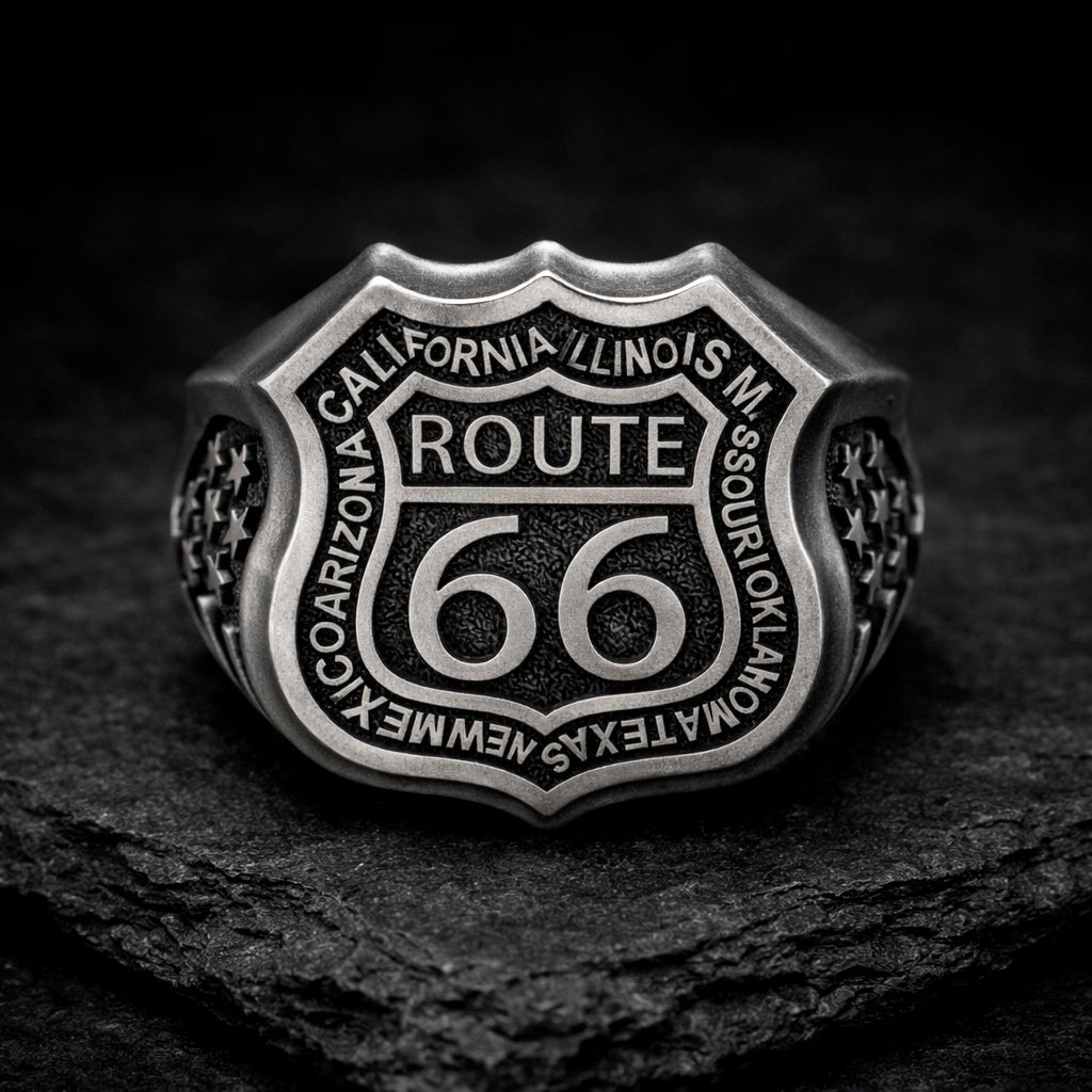 Route 66 sterling silver ring by Indigo Jewelry, men’s biker statement ring crafted from solid 925 silver with oxidized finish. Detailed Route 66 shield engraving with surrounding state names, bold vintage motorcycle jewelry design. Masculine rock style ring inspired by American highway culture, handcrafted silver band for riders, travelers, and lovers of road symbolism.
