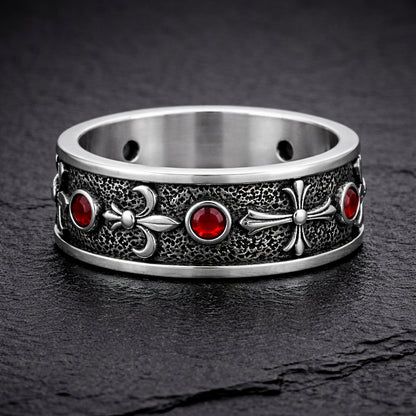 Sterling silver Fleur De Lis ring with deep red garnet stones, featuring an oxidized textured finish and polished heraldic symbols. Medieval gothic band ring inspired by knightly and royal motifs. Solid 925 silver statement ring suitable as a wedding band or symbolic jewelry piece. Elegant, bold, and historically inspired design for men or women, perfect for gothic style, medieval fashion, and unique meaningful gifts.