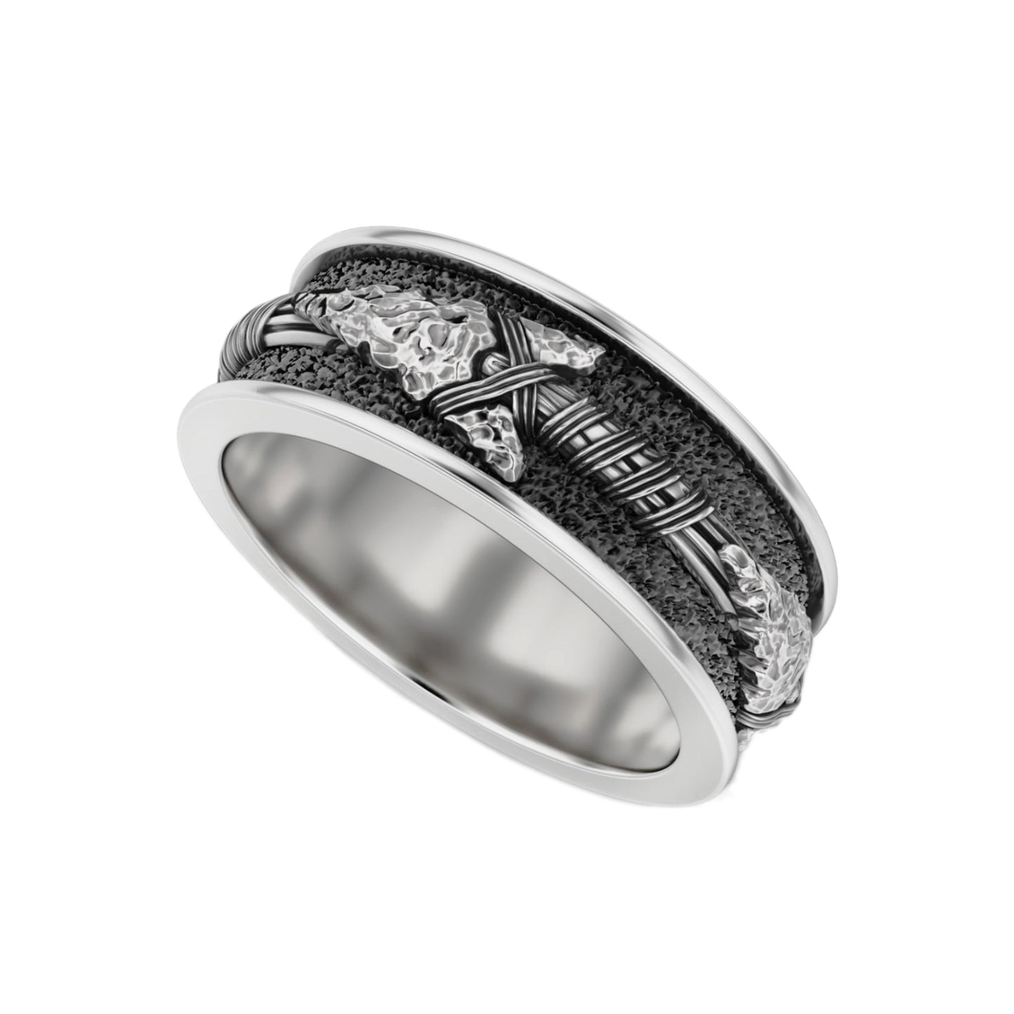 A silver ring with a detailed design featuring a metallic texture and a central motif.