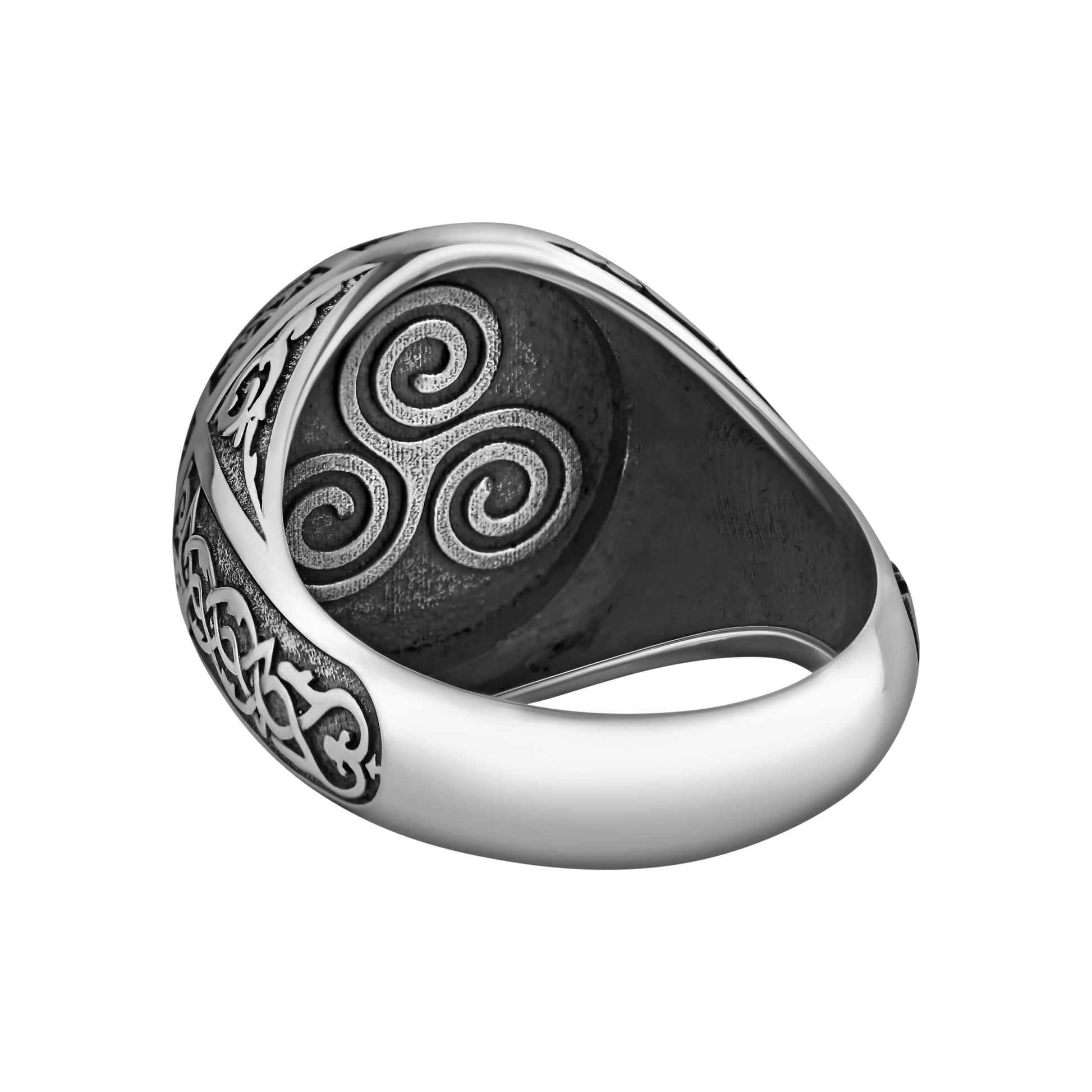 A silver ring with an intricate design featuring a spiral motif.
