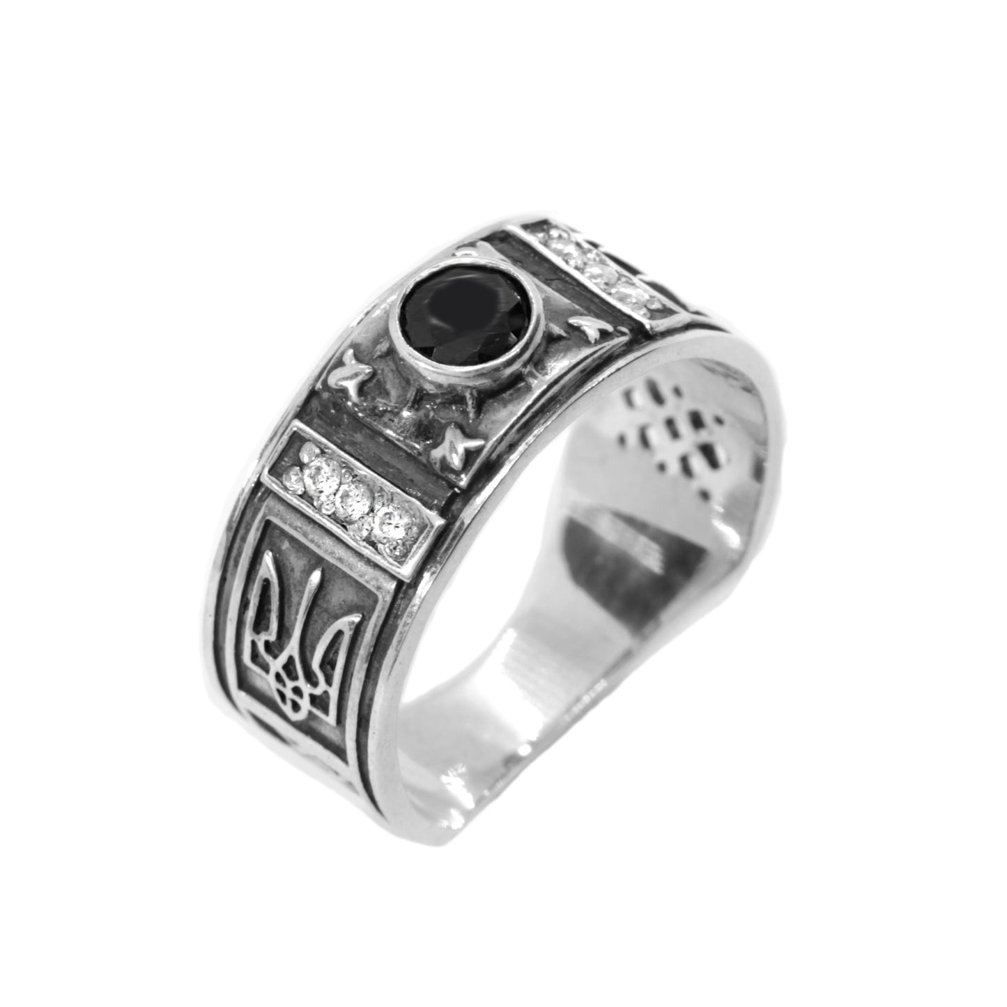 A silver ring with a black gemstone, featuring intricate metalwork and designs.