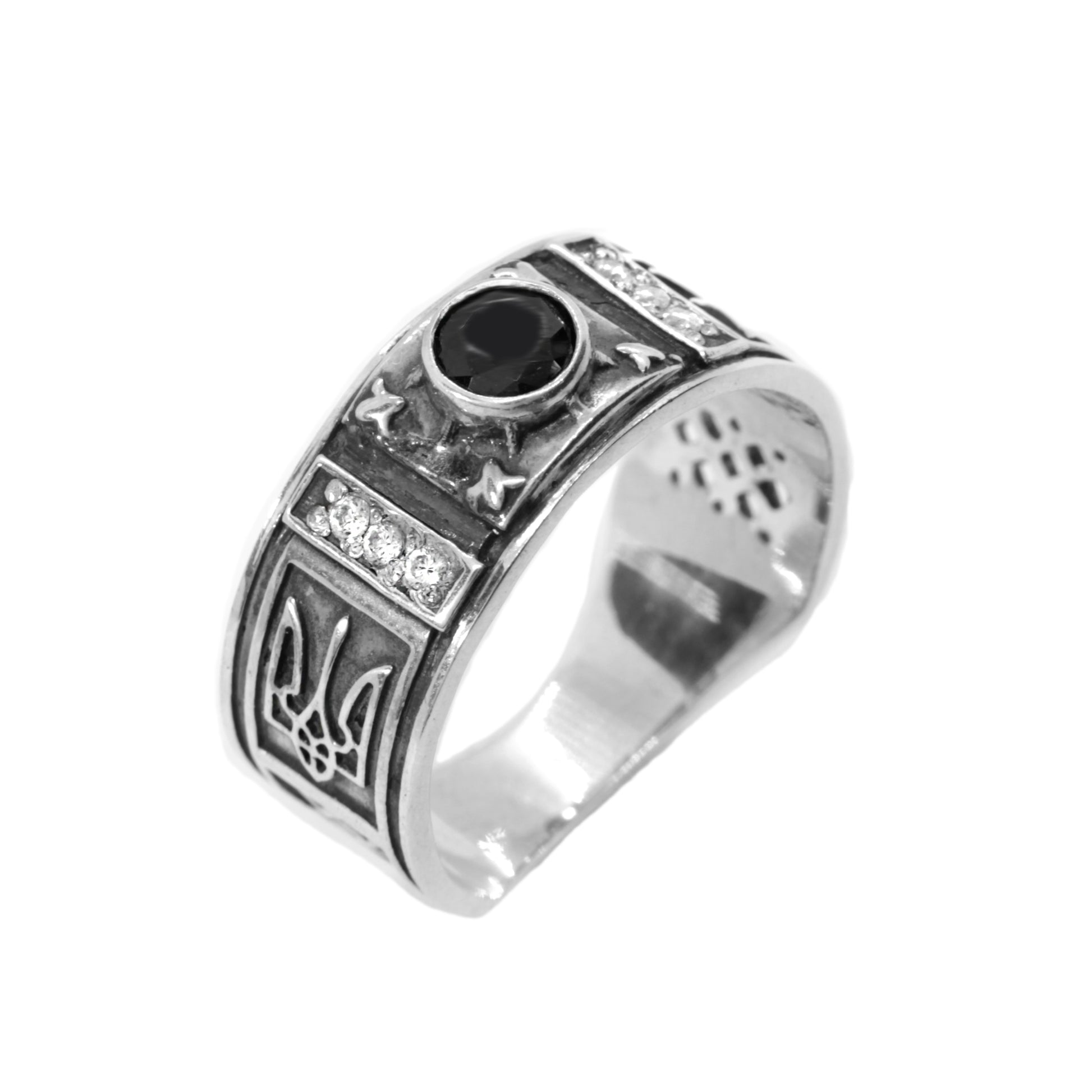 A silver ring with a black gemstone, featuring intricate metalwork and designs.