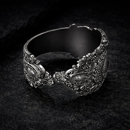 Open oxidized silver thumb ring featuring a detailed portrait of Frida Kahlo. Artistic spoon ring inspired by vintage silverware jewelry, designed as an open ring that wraps tightly around the thumb. Statement thumb ring with sculptural relief and darkened recessed details, handcrafted art jewelry. Frida Kahlo open ring made of blackened silver, bold spoon ring for the thumb, unique wearable art.