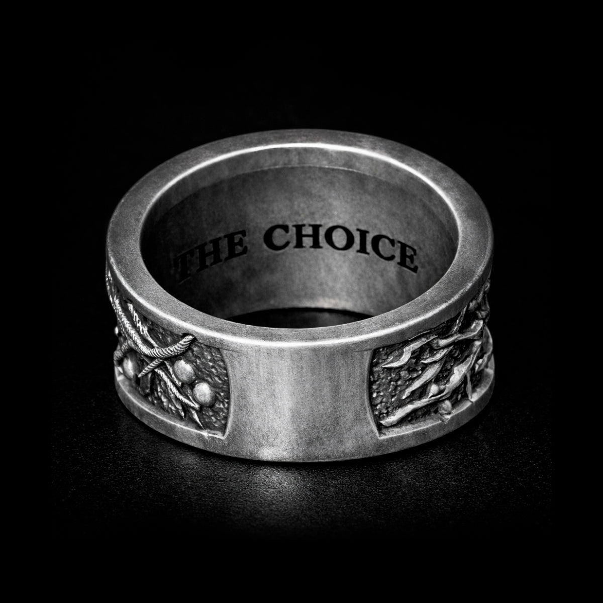 Oxidized sterling silver statement ring by Indigo Jewelry from the Human Paradox Collection. Artistic symbolic design featuring two hands reaching for the forbidden fruit, inspired by Lost Paradise and The Choice concept. Handcrafted silver ring with detailed relief, darkened blackened finish, conceptual jewelry, philosophical ring, art jewelry piece, unique designer silver ring, expressive narrative jewelry, bold textured band, meaningful wearable art.