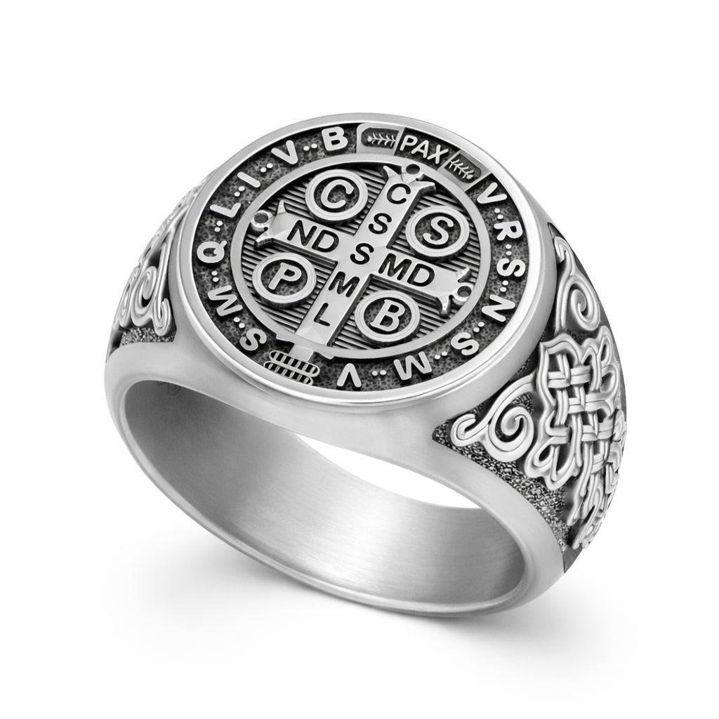 a silver ring with an intricate design and engravings.