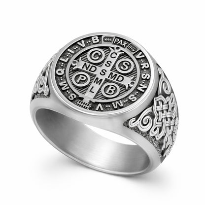 a silver ring with an intricate design and engravings.