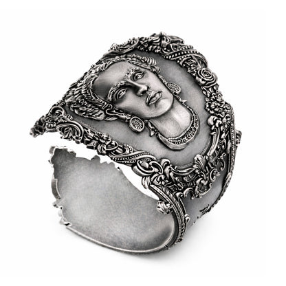 Open oxidized silver spoon thumb ring featuring a detailed portrait of Frida Kahlo. Handmade statement ring inspired by vintage spoon jewelry, designed as an adjustable open band for the thumb. The ring has a wide sculptural form with darkened recessed areas and polished raised details, creating a strong contrast typical of blackened silver. Artistic silver ring inspired by Mexican art and iconic Frida Kahlo portrait, bold wearable art jewelry.