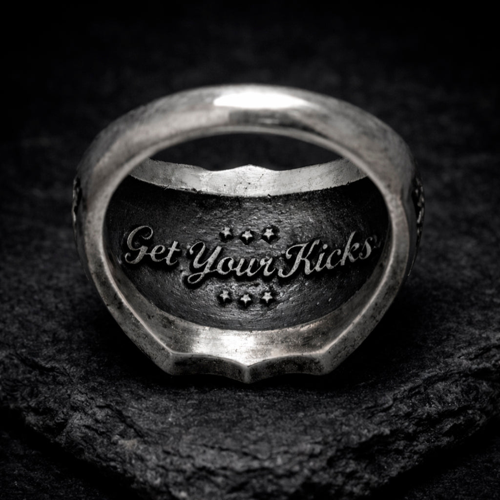 Route 66 sterling silver ring by Indigo Jewelry, men’s biker statement ring crafted from solid 925 silver with oxidized finish. Detailed Route 66 shield engraving with surrounding state names, bold vintage motorcycle jewelry design. Masculine rock style ring inspired by American highway culture, handcrafted silver band for riders, travelers, and lovers of road symbolism.