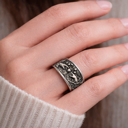 Oxidized sterling silver statement ring by Indigo Jewelry from the Human Paradox Collection. Artistic symbolic design featuring two hands reaching for the forbidden fruit, inspired by Lost Paradise and The Choice concept. Handcrafted silver ring with detailed relief, darkened blackened finish, conceptual jewelry, philosophical ring, art jewelry piece, unique designer silver ring, expressive narrative jewelry, bold textured band, meaningful wearable art.