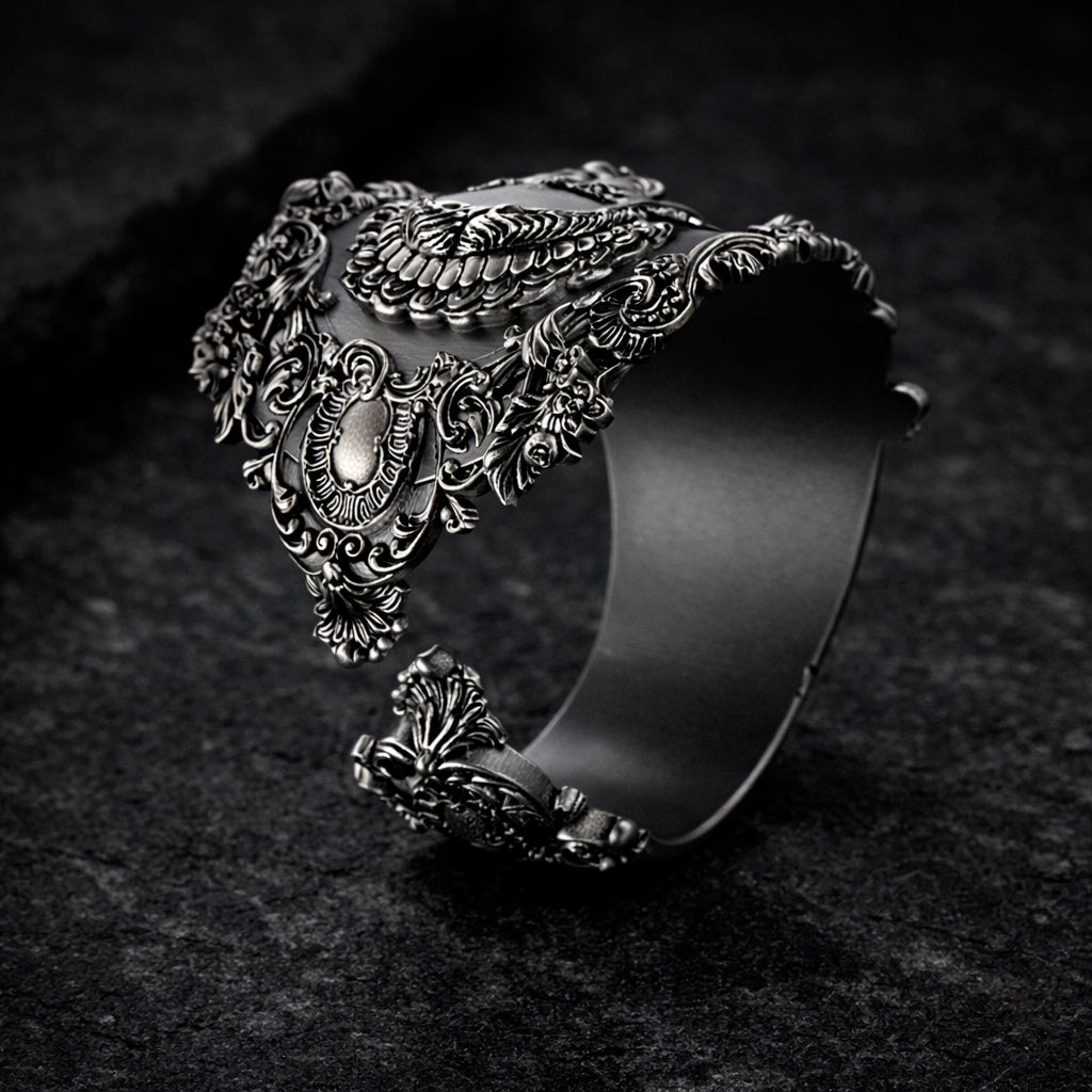 Open oxidized silver thumb ring featuring a detailed portrait of Frida Kahlo. Artistic spoon ring inspired by vintage silverware jewelry, designed as an open ring that wraps tightly around the thumb. Statement thumb ring with sculptural relief and darkened recessed details, handcrafted art jewelry. Frida Kahlo open ring made of blackened silver, bold spoon ring for the thumb, unique wearable art.