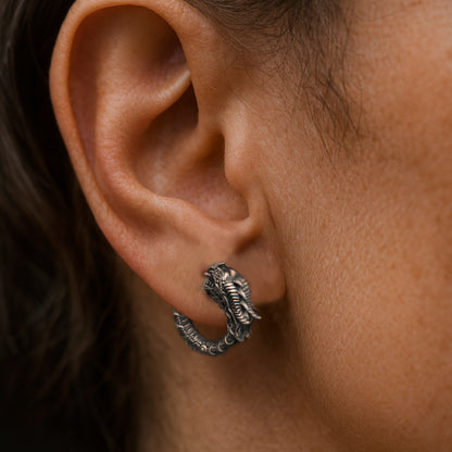 Blackened sterling silver Uroboros dragon hoop earrings with detailed sculpted scales, gothic mythology design, handmade oxidized silver jewelry by INDIGO Jewelry.