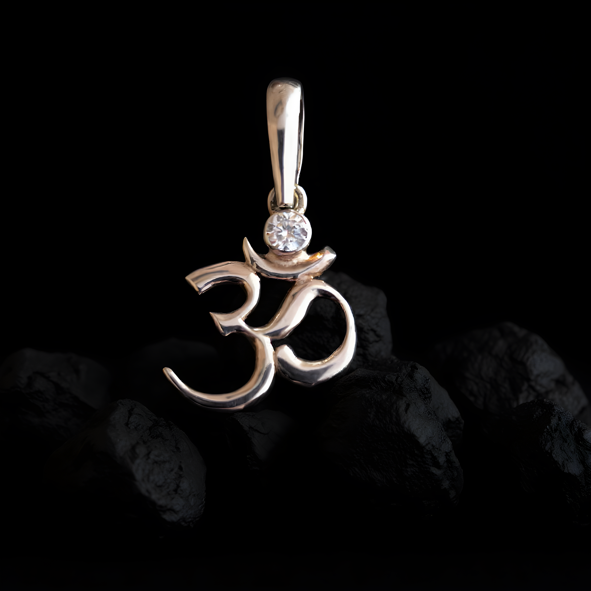 Sterling silver Om symbol pendant with white cubic zirconia, inspired by Hindu and Buddhist spirituality, minimalist design by Indigo Jewelry.