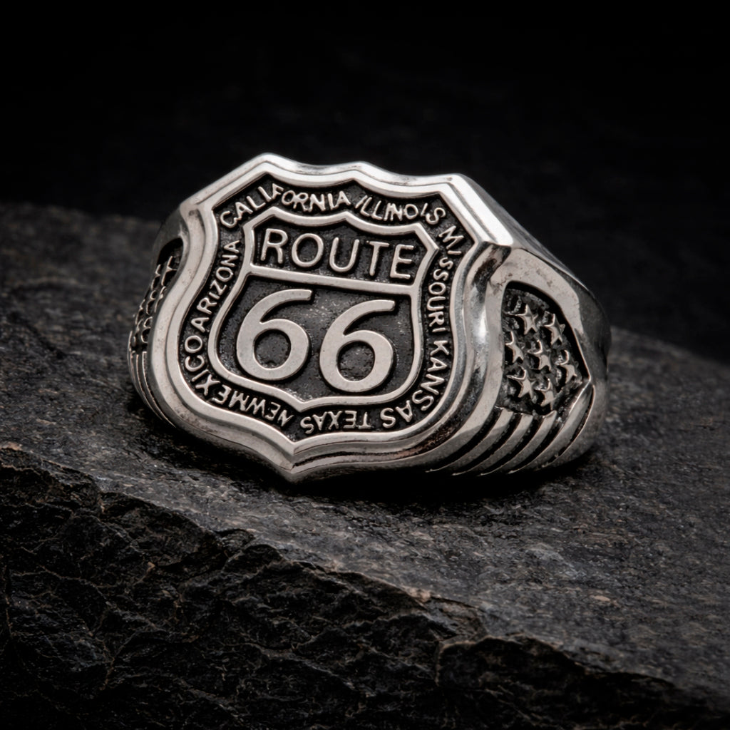 Route 66 sterling silver ring by Indigo Jewelry, men’s biker statement ring crafted from solid 925 silver with oxidized finish. Detailed Route 66 shield engraving with surrounding state names, bold vintage motorcycle jewelry design. Masculine rock style ring inspired by American highway culture, handcrafted silver band for riders, travelers, and lovers of road symbolism.