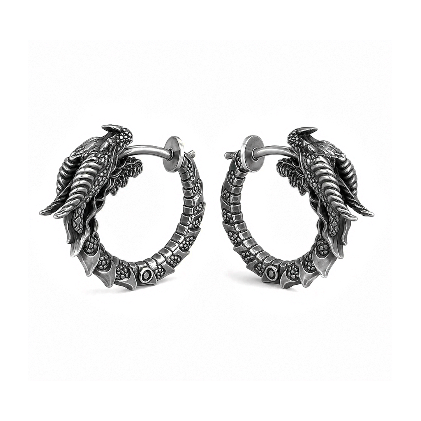 Pair of handcrafted dragon hoop earrings in oxidized sterling silver 925 by INDIGO Jewelry. Realistic gothic earrings featuring detailed dragon heads, sculpted scales, and textured segmented hoops with blackened silver finish for a dark vintage look. Displayed on a clean white background, these fantasy-inspired silver earrings combine medieval, mythical, and gothic aesthetics. Ideal statement jewelry for dragon lovers, fantasy enthusiasts, and alternative fashion.