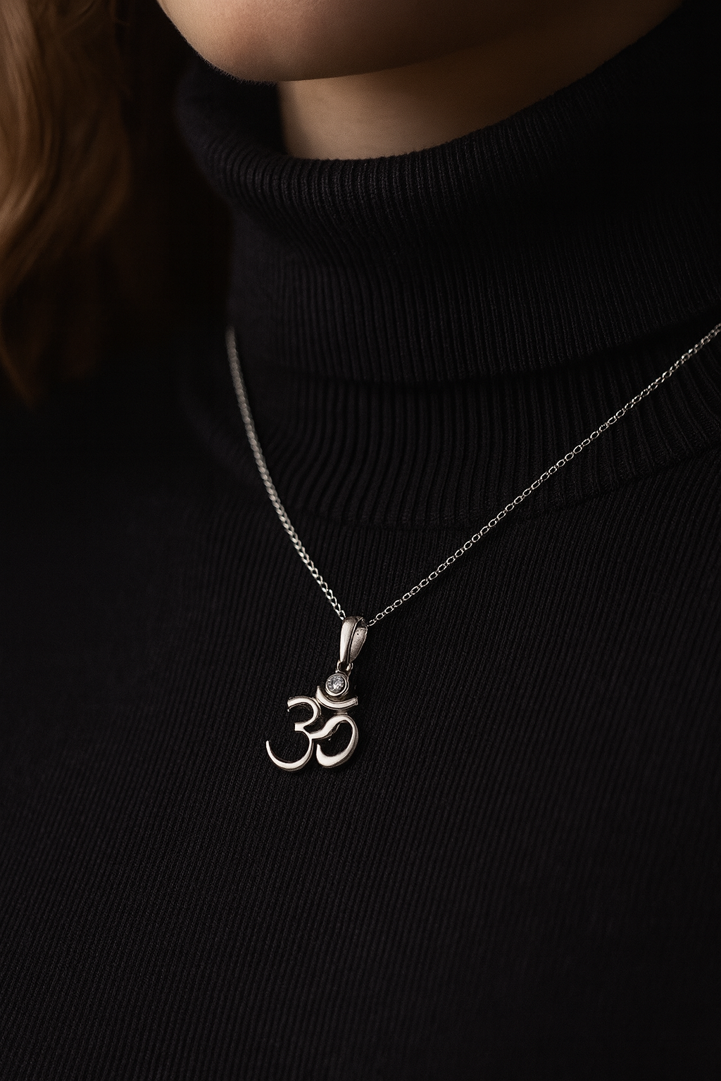 Sterling silver Om symbol pendant with white cubic zirconia, inspired by Hindu and Buddhist spirituality, minimalist design by Indigo Jewelry.