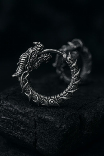 Blackened sterling silver Uroboros dragon hoop earrings with detailed sculpted scales, gothic mythology design, handmade oxidized silver jewelry by INDIGO Jewelry.