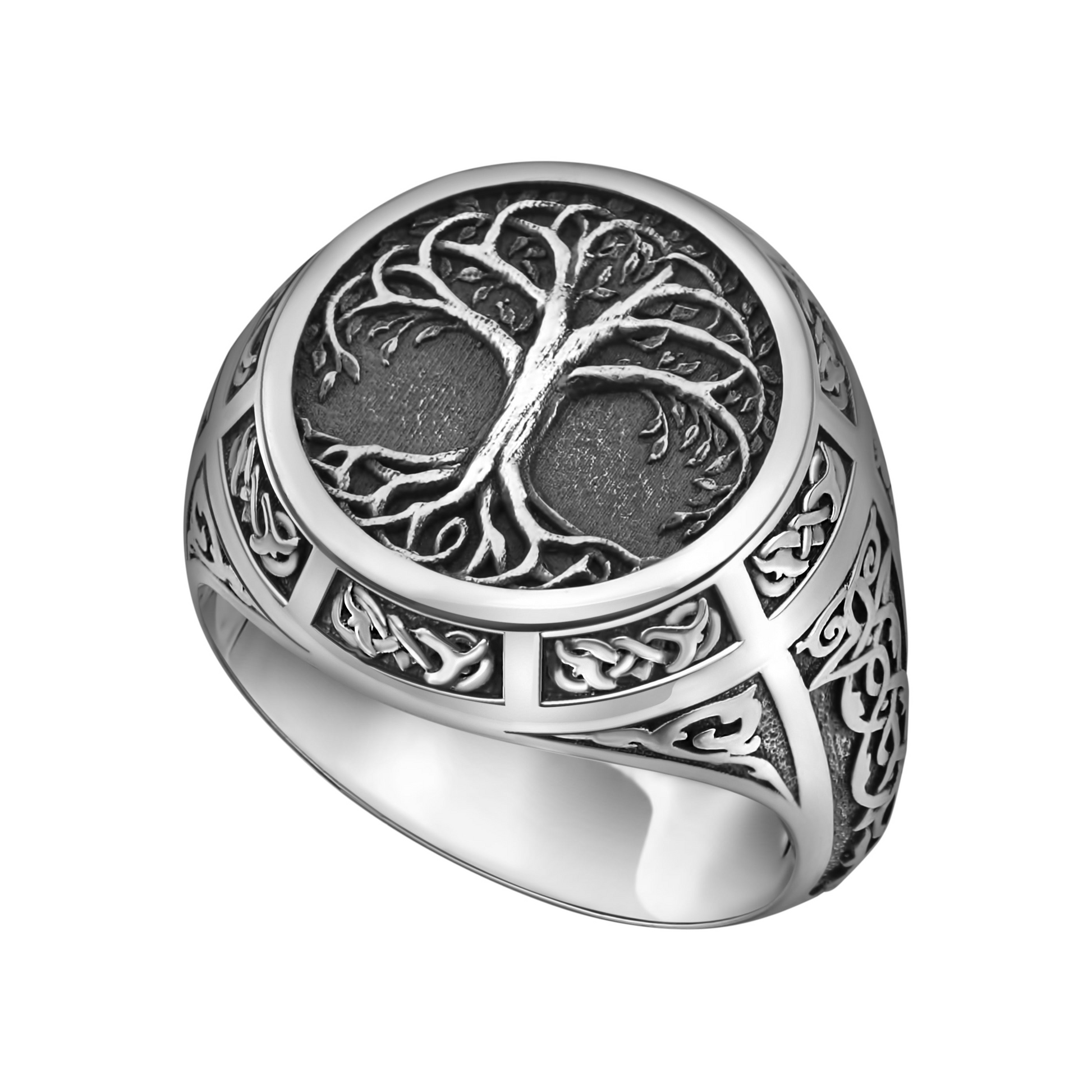 A silver ring with an intricate tree design on the center.