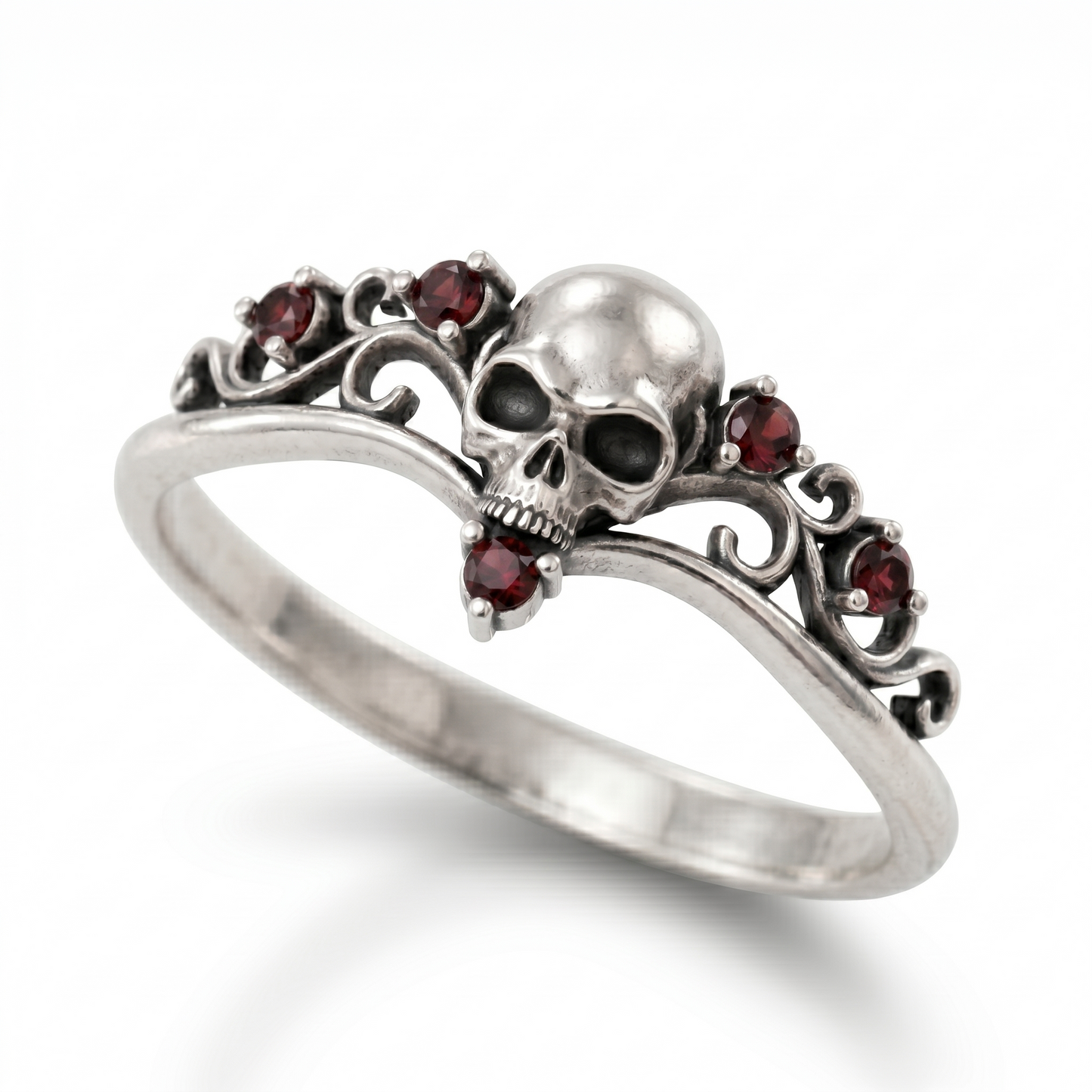 Dainty gothic engagement ring made of blackened 925 sterling silver, featuring a detailed skull design with red cubic zirconia gemstones. Elegant womens silver goth ring in a skull ring style, isolated on a clean white catalog background with a soft gradient shadow.