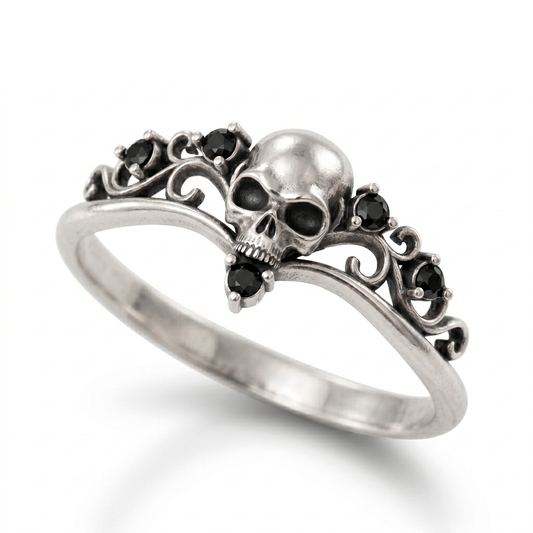 Dainty gothic engagement ring made of blackened 925 sterling silver, featuring a detailed skull design with black gemstones. Elegant womens silver goth ring in a skull ring style, isolated on a clean white catalog background with a soft gradient shadow.