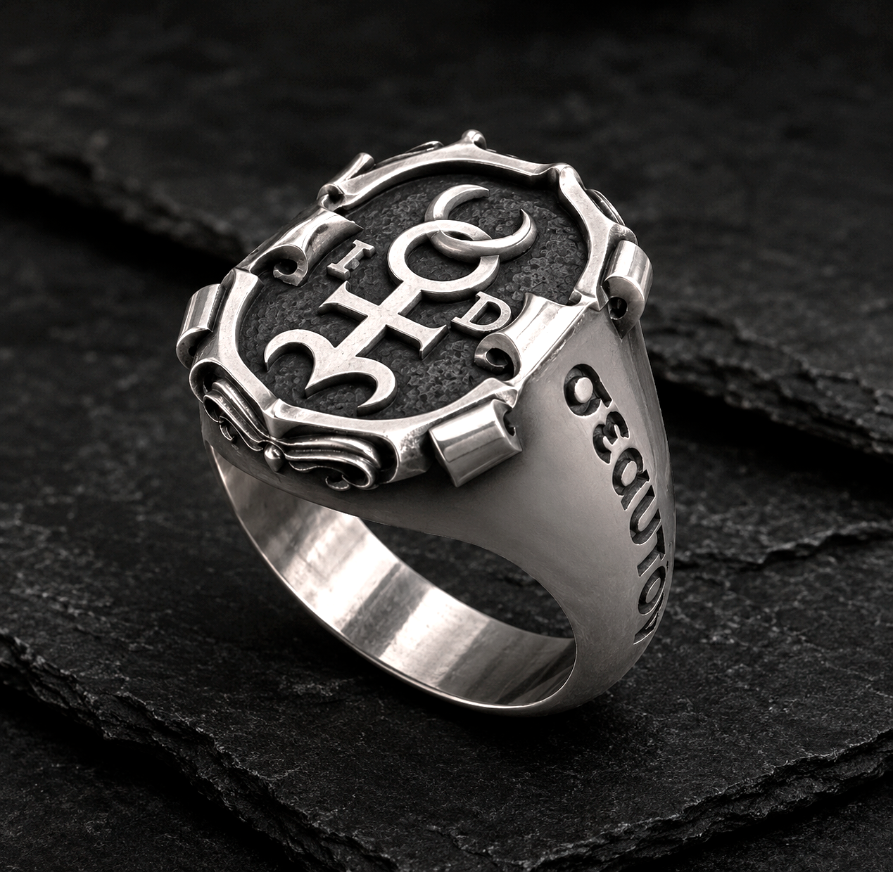 Handcrafted Monas Hieroglyphica signet ring in blackened sterling silver with polished accents on dark slate background by INDIGO Jewelry