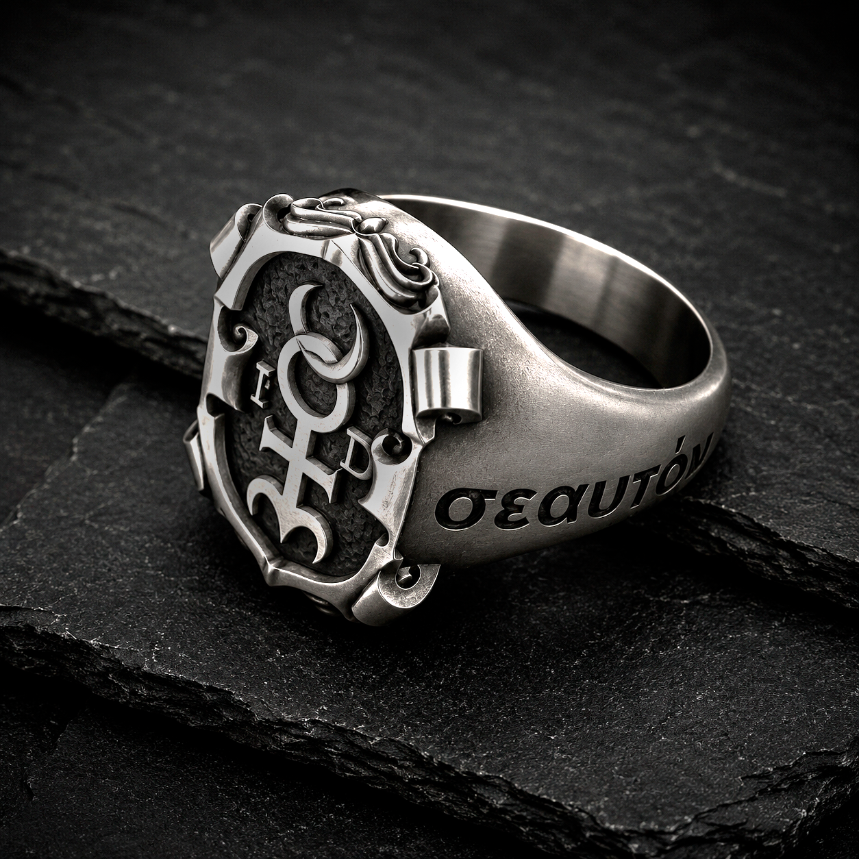 Luxury Hermetic signet ring inspired by Monas Hieroglyphica in oxidized sterling silver photographed on black slate