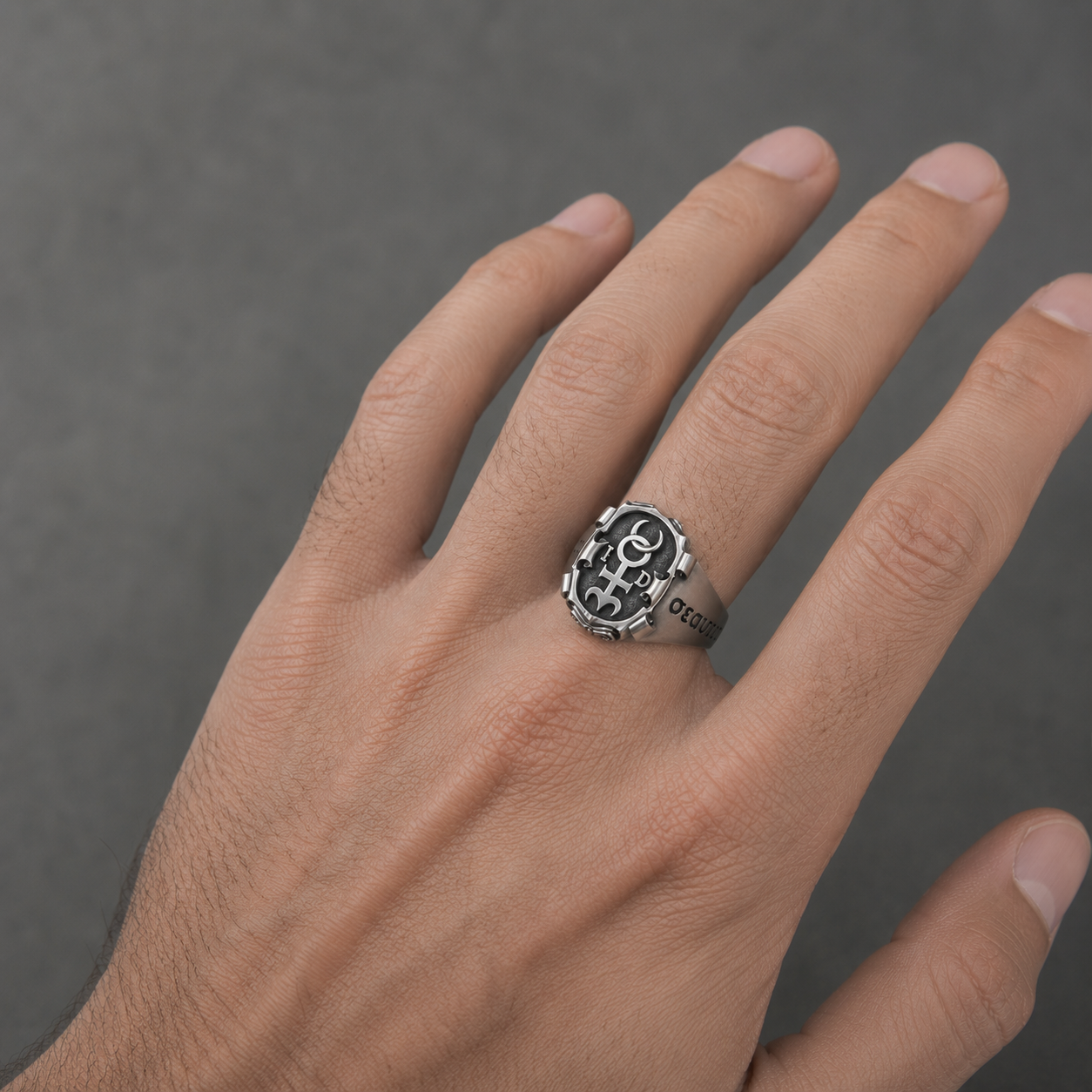 Men’s Monas Hieroglyphica signet ring in oxidized sterling silver worn on hand with polished Hermetic symbol details by INDIGO Jewelry