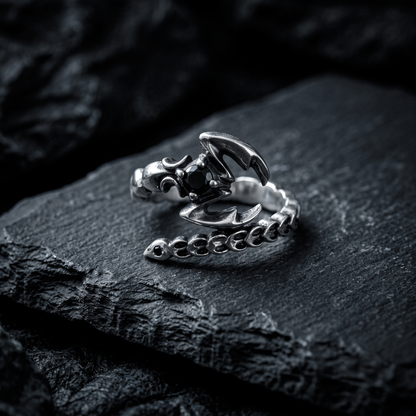 Sterling silver adjustable Scorpio ring with black cubic zirconia on dark background