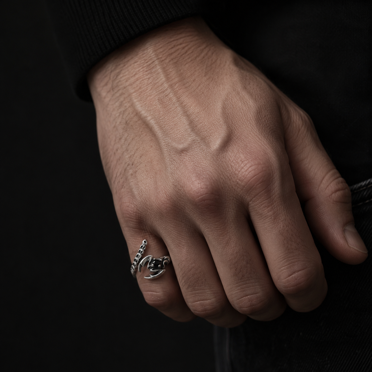 Macro close-up of handcrafted adjustable Scorpio ring in solid sterling silver with black cubic zirconia