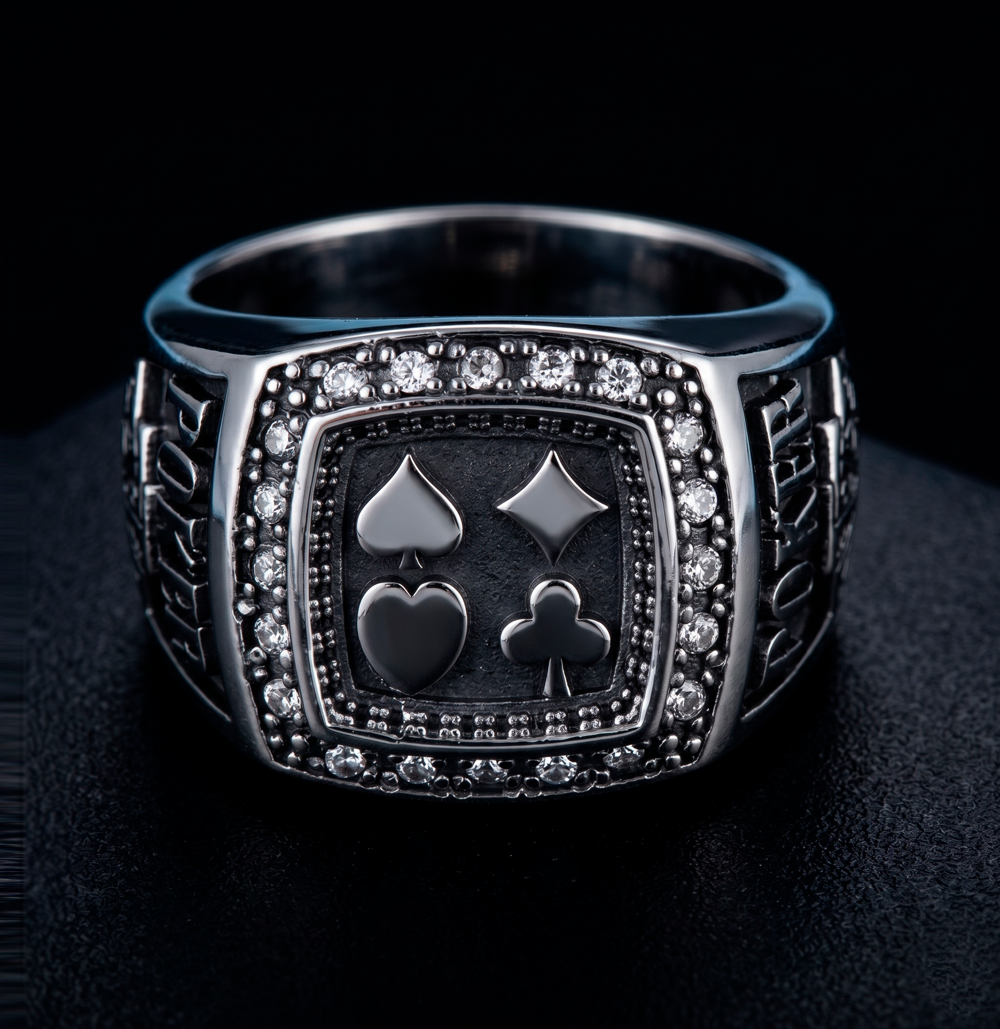 Front view of a luxurious men's 925 silver ring with engraved poker card suits by Indigo Jewelry.