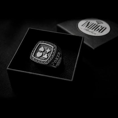 The exclusive silver poker ring unboxed inside the signature black Indigo Jewelry gift packaging.