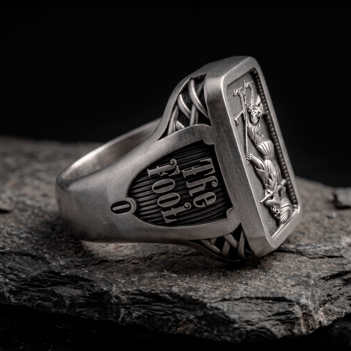 Side view of The Fool Tarot silver signet ring by INDIGO Jewelry Atelier with engraved tarot symbolism and oxidized finish