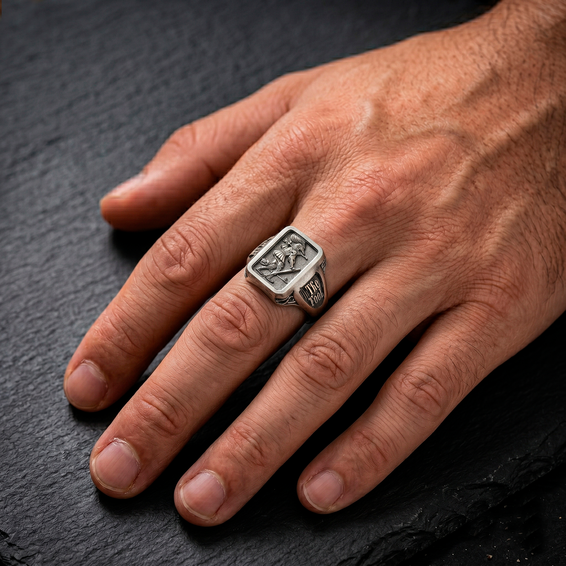 The Fool Tarot signet ring worn on male hand by INDIGO Jewelry Atelier, symbolic sterling silver tarot jewelry