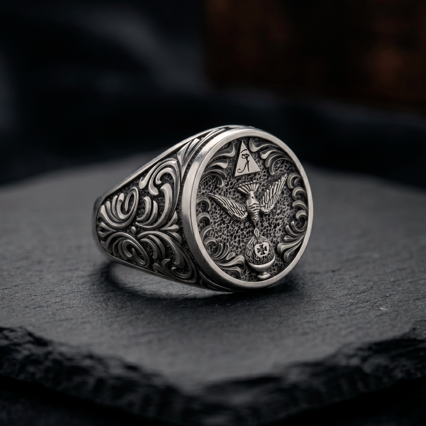 Angled close-up of Thelema OTO mens signet ring with antique blackened silver finish, handcrafted jewelry, INDIGO Jewelry Atelier